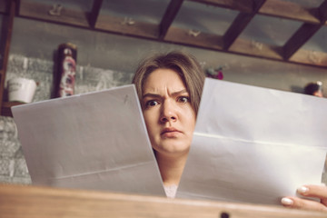 serious girl looks at the documents in surprise