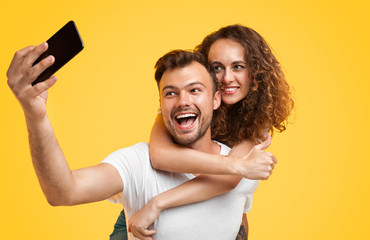 Loving couple taking selfie with phone