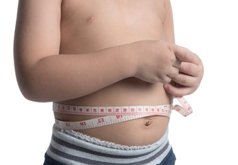 Boy measuring his belly with measurement tape