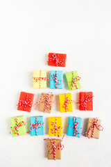 Christmas tree of colorful gift boxes on white background, flat lay