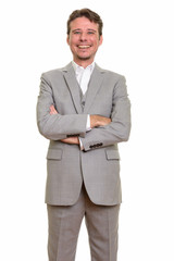 Happy Caucasian businessman smiling and looking at camera
