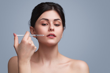 Sensual flawless model doing cosmetic injection