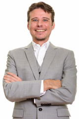 Happy Caucasian businessman smiling and looking at camera