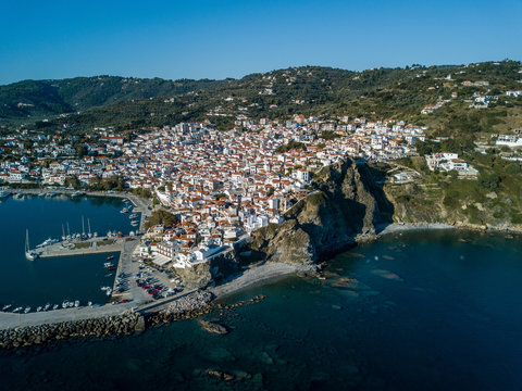 Old Town of Skopelos and harbor from above, island of Skopelos, Greece, Northern Sporades , Aegean Sea - Aerial Image by Drone