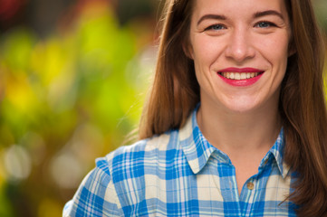 Positive cute young woman looking into camera