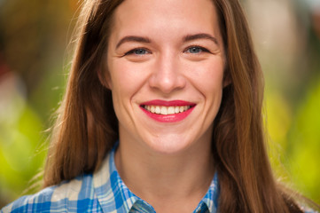 Positive cute young woman looking into camera