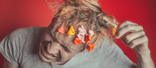 Gum in his head. Portrait of man with chewing gum in his head. Man with hair covered in food....