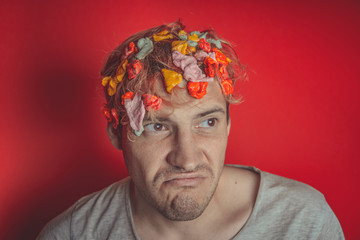 Gum in his head. Portrait of man with chewing gum in his head. Man with hair covered in food....