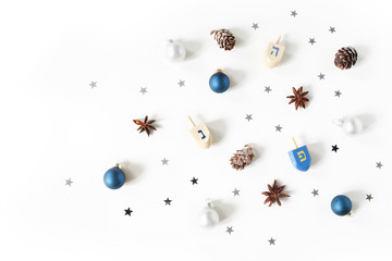 Hanukkah styled stock composition. Decorative pattern. Wooden dreidel toys, larch cones, anise and...
