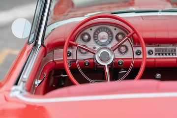 Deurstickers Close up of vintage red car driver's wheel and dashboard © Roberto Vivancos