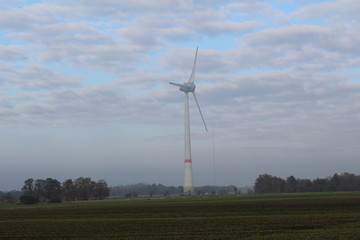 Windmill in front of a hazy autumn sky 