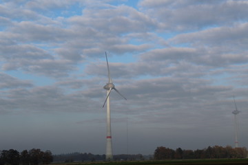 Windmill in front of a hazy autumn sky 