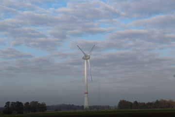 Windmill in front of a hazy autumn sky 