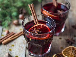 Traditional winter alcoholic drink - mulled wine. Hot wine with fruits and spices in glasses