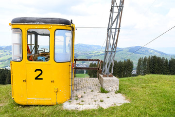 Yellow unused cable car during summer