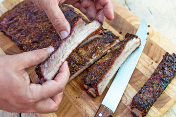 Cutting pork ribs on cutting board