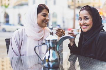 Two arabian girls spending time togehter outdoor making activities
