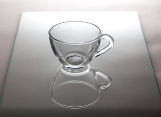 Glass cup for tea is on glass