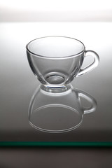 Glass cup for tea is on glass