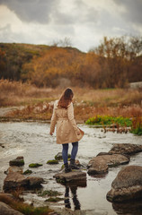 young woman walking in the park and crossing river