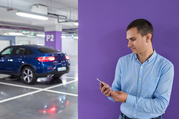 Man with a telephone on the underground parking