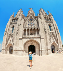 Tourist traveler girl on mount Tibidabo look at the Church of Sacred Heart in Barcelona