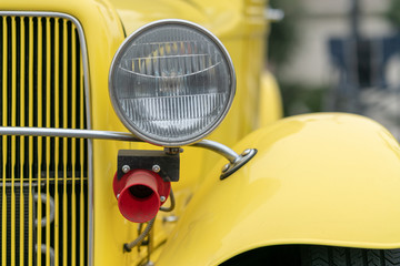 Close up of vintage yellow car bumber and lamps