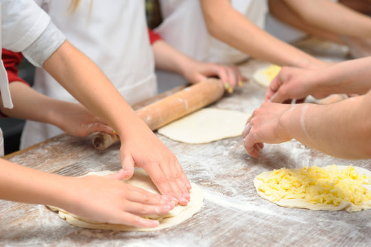 Young children make dough products. Hands closeup
