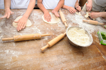 Young children make dough products. Hands closeup
