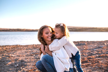 Mum and daughter having fun together outdoors.