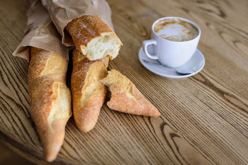French baguettes and coffee on the wooden table	
