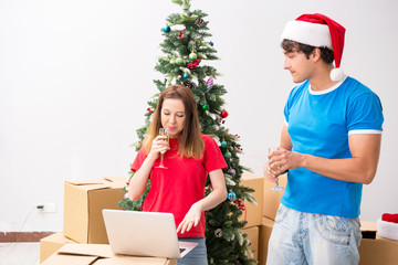 Young family celebrating christmas in new home