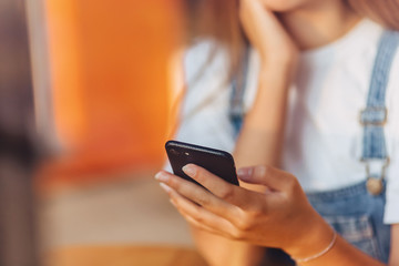 young attractive pretty girl at cafe with coffee and phone throuth window glass