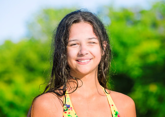 Pretty teenage girl wearing swimsuit at river