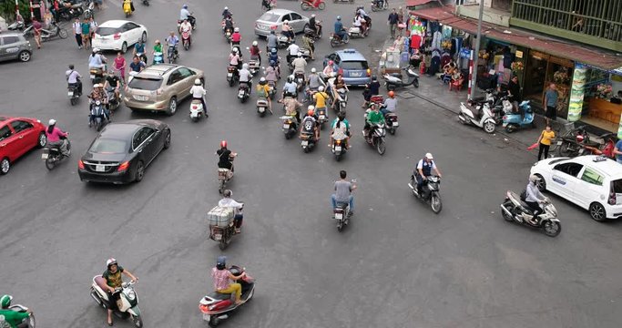 Hanoi, Vietnam-09/2018: Aerial view city street in rush hour, traffic noise. Traffic in downtown Hanoi capital with lots of motorcycles, motorbike, bus, car, and people walking crowded on the street