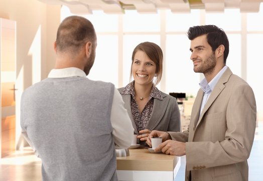 Business people talking at coffee table at office