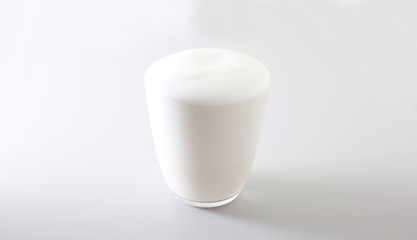 milk foam glass on a light background