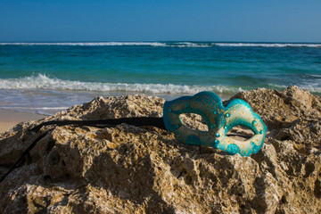 Fototapeta na wymiar masquerade party mask on beach view