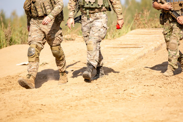 Fototapeta premium group of soldiers on the Outdoor on army exercises. war, army, technology and people concept