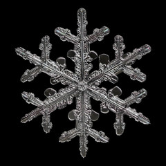 Extreme magnification - Real snowflake isolated on black background