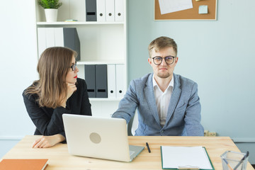 Business, emotions and people concept - Two angry and exhausted workers at working place. People wearing the packages on their heads with pictured emotions