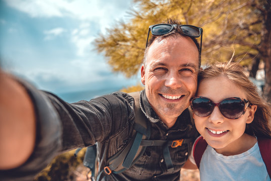 Father and daughter making selfie with smart phone