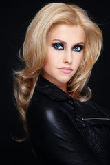 Fototapeta premium Young beautiful sexy blonde girl in black leather jacket