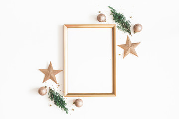 Christmas composition. Photo frame, golden decorations, fir tree branches on white background. Christmas, winter, new year concept. Flat lay, top view, copy space