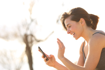Profile of a happy woman having a video call