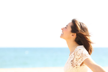 Smiley lady breathing fresh air on the beach