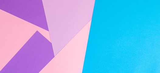 Color papers geometry flat composition background with pink violet and blue tones