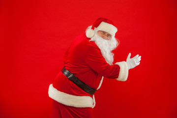 Running Santa Claus red background Merry Christmas.