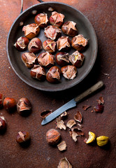Hot baked chestnuts in a pan. View from above.