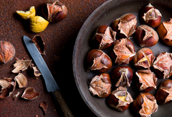 Hot baked chestnuts in a pan. View from above.